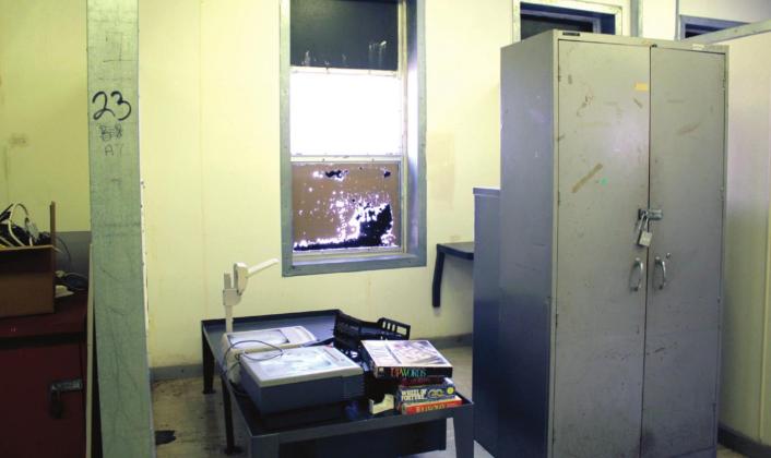 The old sleeping areas at COJC had painted-over windows, a metal bed and desk, and no doors for privacy or security. Some of the old residential buildings were 100 years old, and most have been torn down. A few, such as this, are being considered for other purposes.