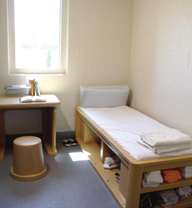 Every bedroom at the new Next Generation Campus has a window with safety glass, a bed with storage shelves, a desk and stool, and a locking door. The campus includes seven 16- bed cottages and a new clinic/intake center.
