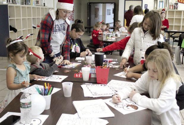Children and adults enjoy coloring during the Second Annual Breakfast with Santa, held at Shawnee Middle School on Nov. 30.