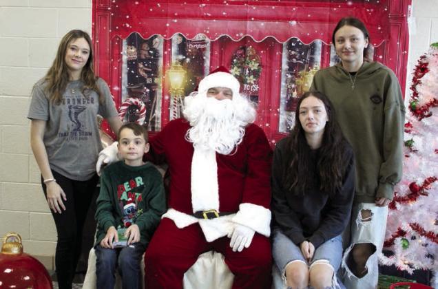 Santa poses with, from left, wrestler Bella Tipton, Benny Nagle, 9, wrestler Payton Ayers and senior Kaitlyn Wiley during the Breakfast with Santa.