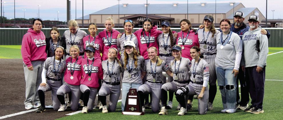 The Asher Lady Indians, with their managers and coaches, pose with the Class B State Slow Pitch Tournament Runner-Up trophy, after winning two games and losing one at FireLake Ball Fields on May 6. They end their season with a record of 28-9.
