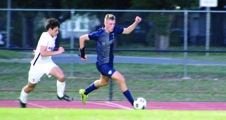 Shawnee’s Camden Sateren drives toward the goal during the home game against Bishop Kelley on April 14. The Wolves lost, 0-5. Countywide &amp;amp; Sun/Natasha Dunagan