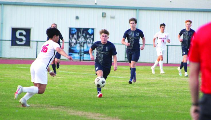 Shawnee’s Rhett Neese (#6) tries to keep possession of the ball during the home game against Bishop Kelley.