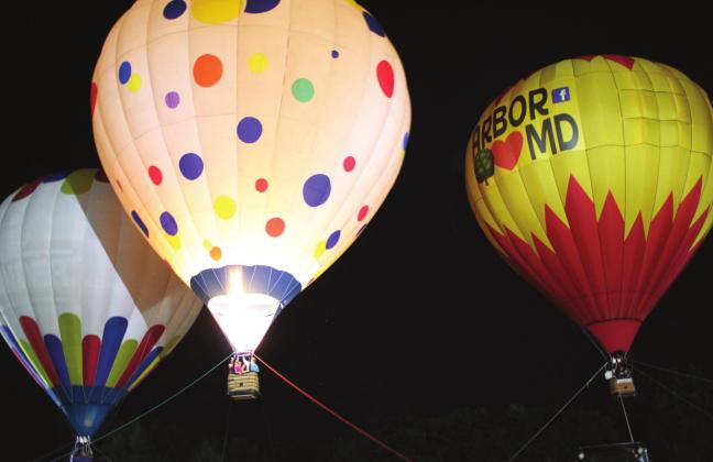 A polka dot hot-air balloon illuminates its two nearby balloons during the Balloon Glow of the FireLake Fireflight Balloon Festival on Aug. 14. Countywide &amp;amp; Sun/Natasha Dunagan