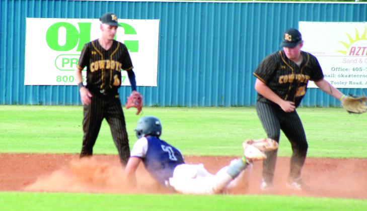 Asher sophomore Mitchell Skender dives into second base for the steal and is safe, due to a dropped ball, during the first inning of the Aug. 25 home game against Kiowa. The Asher Indians beat the Cowboys, 10-0. Photos by Natasha Dunagan, Countywide &amp;amp; Sun