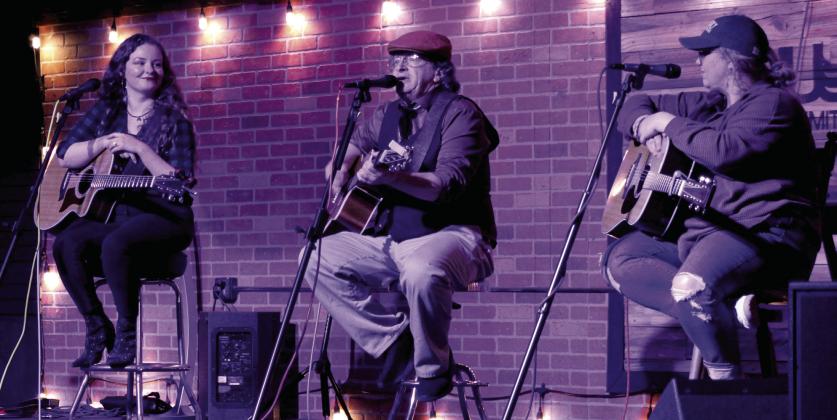 Dave Laurance sings "My Guardian Angel" as Miranda Mulkey, left, and Jenna McLaughlin, right, listen during Singer-Songwriter Night at Music Unlimited on Jan. 2. Jacob McElroy, Ed Combs and Joy Moldenhauer also performed, and Brad Sullivan, now of Colorado, was the featured artist. The free event restarted in September 2025 and will continue on the first Friday of each month at 7 pm. Donations are taken to support the featured artist. Natasha Dunagan, Countywide &amp; Sun