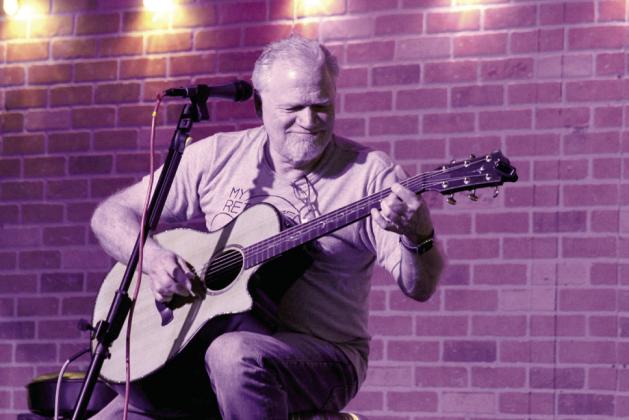 Shawnee native, Brad Sullivan, now of Littleton, CO, plays an instrumental swing song he wrote about the bridge at Garrett's Lake Road called "Swingin' Bridge" during Singer-Songwriter Night at Music Unlimited on Jan. 2. Sullivan was the featured artist at the event. Natasha Dunagan, Countywide &amp; Sun