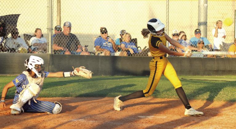 Tecumseh senior Haley Mansell gets a hit before taking a walk, as Bethel senior Layla Menhusen reaches for the catch, during the game at Tecumseh on Sept. 23. Natasha Dunagan, Countywide &amp;amp; Sun
