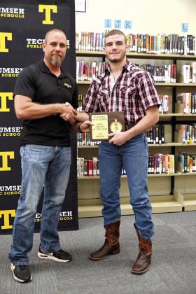 Tecumseh Wrestling Coach Billy Don Sigman presents the Male Athlete of the Year Award to J.D. Sigman during the Tecumseh High School Athletic Awards on May 13. Photo provided by Kenetta Lisenbee.