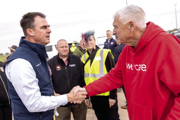 Oklahoma Governor Kevin Stitt (left) and Shawnee Mayor Ed Bolt meet in FireLake Arena’s parking lot to discuss the city’s emergency declaration. Rep. Dell Kerbs and Shawnee City Manager Andrea Weckmueller-Behringer are in the background listening to the exchange. Photo provided