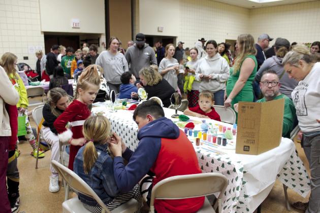 Four children get face paintings from members of the Home Church at the Grinchmas Whoville event, held in the Tecumseh City Hall Auditorium on Nov. 30. Home Church also brought a live nativity (minus live animals) which set up in the Tecumseh Chambers and included story time.