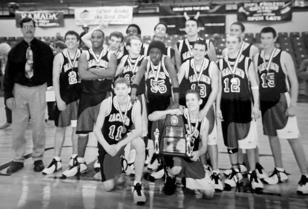 Coach Bill Grogan, far left, poses with his Macomb High School boys basketball team in 2005 after winning the Pottawatomie County Basketball Tournament Championship at OBU. As a Class B team, they beat Dale, McLoud and Tecumseh and went on to play in the State Semifinals. Photo provided.