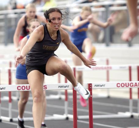 Tecumseh's Katelyn Tonubbee clears a hurdle in the 100-meter hurdles at North Rock Creek on April 1. Bethel, North Rock Creek, and Mc-Loud also participated in the track meet. Natasha Dunagan, Countywide &amp;amp; Sun