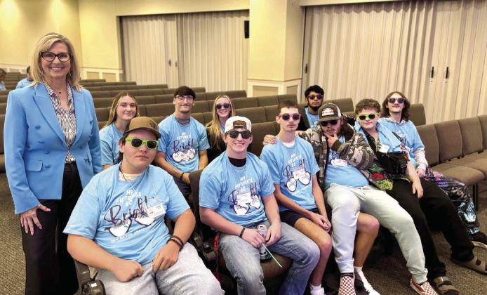 Jill Spencer, Chair of the Avedis Foundation Board and Senior Vice President at First United Bank Tecumseh delivered an inspiring message to the Shawnee High School seniors at the My Future’s Bright Senior Conference. Pictured above is Spencer with a group of seniors at the event. Photo provided by SPS