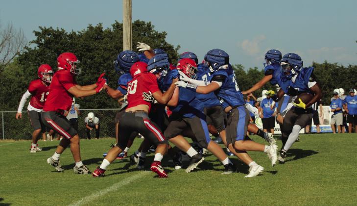 Bethel senior Ezra Powis (far right) carries the ball in a scrimmage against NRC. Cheyanna Dietz, Countywide &amp;amp; Sun