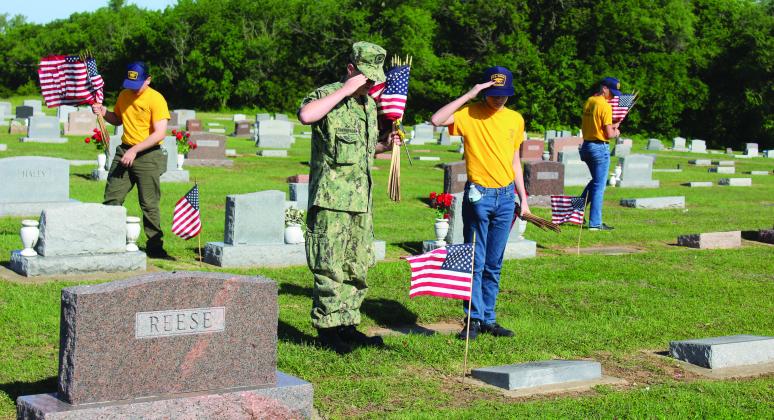 U.S. Naval Sea Cadets SN Zane Finkenbinder and Recruit Carver Conkling salute the grave of WWI veteran William Garsee, as SR Mehmet Akkus, far left, and SR Zackery Henderson look for more veterans' graves at Tecumseh Cemetery on May 17. See full cutline below. Natasha Dunagan, Countywide &amp; Sun