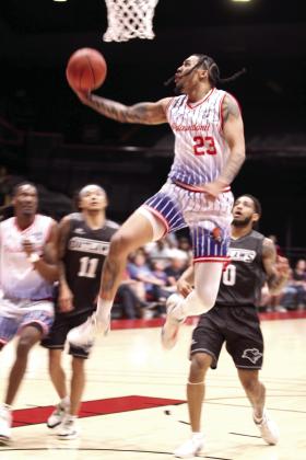 Potawatomi Fire Forward Isaiah Wade takes an assist from Deshawn Munson and puts it in the basket during the second quarter of the Central Division Finals Game 2.
