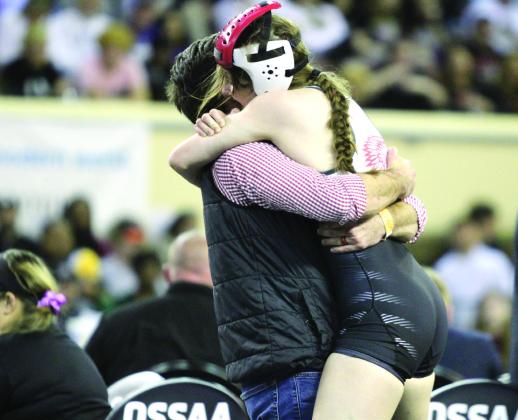 McLoud junior Launa Troutt gets a hug from Head Wrestling Coach William Winters after winning her match at the OSSAA Class 5A Girls Wrestling State Championship. Troutt was the second girls wrestling state champion at McLoud, after Carli Sisco won earlier, and their team took first in the state. Troutt recently reached 100 career wins, as well. Countywide &amp; Sun/Natasha Dunagan