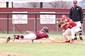 North Rock Creek’s 1st baseman Jesse Todd stretches for the catch and possible out as the opponent dives back to the base.