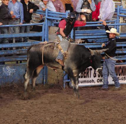 Colton Johnson, of Shawnee, begins his bull ride during the International Finals Youth Rodeo on July 7. File photo