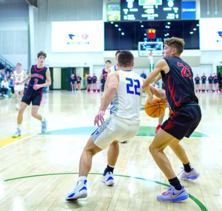 North Rock Creek senior Jordan Coody tries to guard the ball from Bethel’s Bray Bussell during the Bethel home game at OBU on Jan. 13. Coody reached 1,000 points that night. File photo