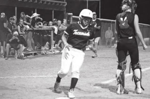 Tecumseh’s Zariyah Masquas runs across home plate after being batted in by Bristin Hayes to win the game against Blanchard in the seventh inning, Oct. 7, as Head Coach Chad Trahan fist pumps behind her. The score for that game was 0-0 until that point. Tecumseh won all three of their regional games on Oct. 7 and 8 to advance to state today (Oct. 14) at 11 am. Countywide &amp;amp; Sun/Natasha Dunagan