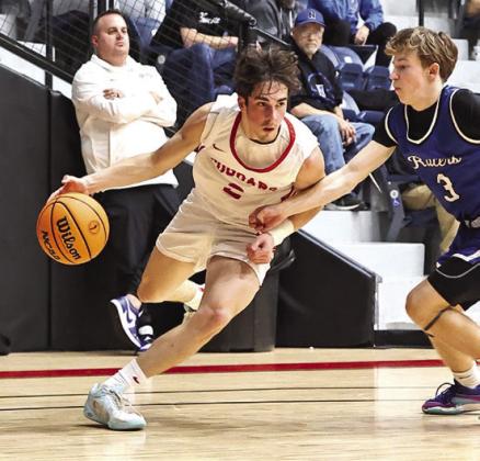 NRCs David King, right, drives the baseline. King retur ned to action after breaking his wrist four weeks ago.