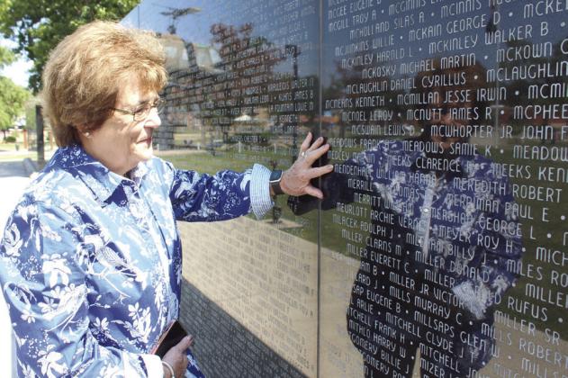 Nancy Ford of Shawnee points out her father's name, William H. Mendenhall, on the Oklahoma Memorial Wall at Woodland Veteran's Park on Sept. 9. Ford recently donated to the Dolphin Scholarship Foundation in memory of her father, who lost his life when the USS Lagarto sank in May 1945. It will pay for scholarships for those serving on the new USS Oklahoma. Natasha Dunagan, Countywide &amp;amp; Sun