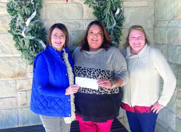 Kathy Laster, Ph.D. President &amp;amp; CEO Avedis Foundation, presents a check to Tiffany Walker, Executive Director Shawnee Bridges Out of Poverty. Also pictured is Avedis Foundation Program Director Tracy Meeuswen. Photo provided