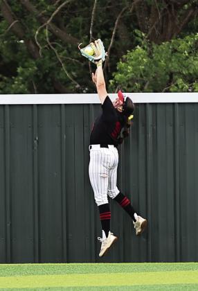 North Rock Creek's Morgan Campbell robs Tecumseh of a three run homerun. NRC beat Tecumseh 6-4 in the semi-finals. Photo courtesy of Gowin Photography