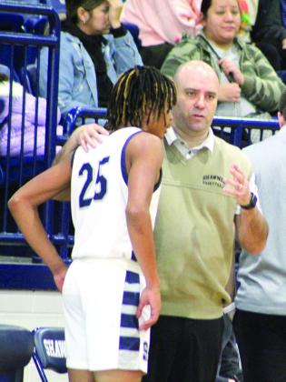 Shawnee Head Basketball Coach Eric Litherland talks with Zylon Campbell after the athlete received a technical foul during the Lowe’s/ Sehorn Yamaha Shawnee Invitational game against Broken Arrow on Jan. 19.