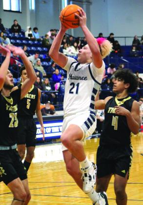 Shawnee’s J.J. McClain tries for a basket in the first quarter of the game against Broken Arrow. The Wolves lost that game, 42-69.