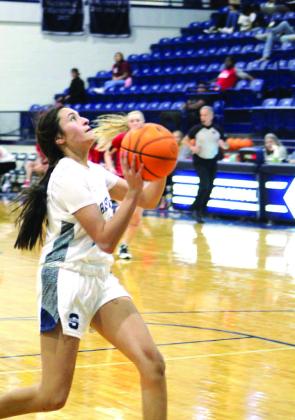 After stealing the ball, Shawnee’s Daley Rice drives to the basket and makes two points in the third quarter of the game with Mustang during the Lowe’s/Sehorn Yamaha Shawnee Invitational on Jan. 21. In the previous two days, they also won against McAlester, 56-48, and lost to Jenks, 28-56.