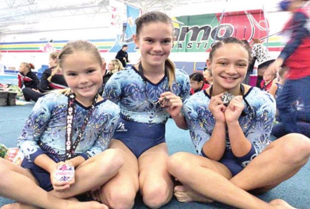 Level 3 gymnasts pictured to the left are Alivia Kohn, Emma Kohn, and Kalila Duck. Photo provided