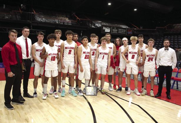 The McLoud Redskins pose with their coaches after a harrowing final game against Prague, which brought them up to one point in the lead in the last minute, only to lose by one point, 63-64, when the Red Devils scored in the last seconds. During Bethel’s First United Basketball Classic, held at FireLake Arena, Dec. 8-10, McLoud beat Byng, 66-61, and Perkins-Tryon, in overtime, 60-59, before becoming the runners-up for the boys. Countywide &amp;amp; Sun/Natasha Dunagan