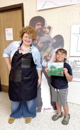 Sylwia Partyka, Director of Development at the Mabee-Gerrer Museum of Art, poses with Tanner Duff, 8, of Bethel during the Art Mania event held on Tuesday. The Bob Ross-themed event was free, full of 'happy trees' and open to all ages! Photo provided