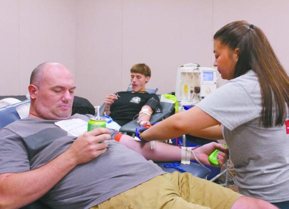 Sammy Taylor of Tecumseh diverts his attention as Maritza Zamora, with the Oklahoma Blood Institute, starts his blood collection during the 'Making a Difference: School Prep for Success' event at the Shawnee Public Library on Aug. 9. Also shown is Aubrey Pardue of Tecumseh, and it was the second time for both him and Taylor to donate. Blood donors received shirts and tickets to Frontier City or Six Flags Hurricane Harbor. Natasha Dunagan, Countywide &amp;amp; Sun