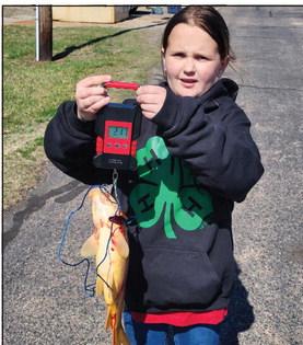 Bethel 4-H Club member Jessilynn Kuchynka uses a hanging scale to weigh a buffalo carp during the OKFITS 4-H Fishing Tournament at Shawnee Twin Lake #1, March 9. Photo provided.