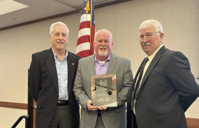 SSC Educational Foundation Vice Chair Mark Schell (left) and Chair Lance Wortham (center) accept the David L. Boren Community Achievement Award presented by Seminole Chamber of Commerce Chairman Rodney Sutterfield (right) at the chamber’s annual banquet on Feb. 6. Photo provided