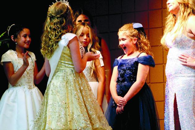 Callie Jane Hart, 8, reacts with surprise at being presented the crown for Junior Miss Frontier Days by 2021 Junior Miss Contessa Boatman during the Pageant on Sept. 11 at Tecumseh City Hall Auditorium. Also shown are Junior contestants Ember McPherson, 9, and Paetyn Fields, 10. Countywide &amp; Sun/Natasha Dunagan