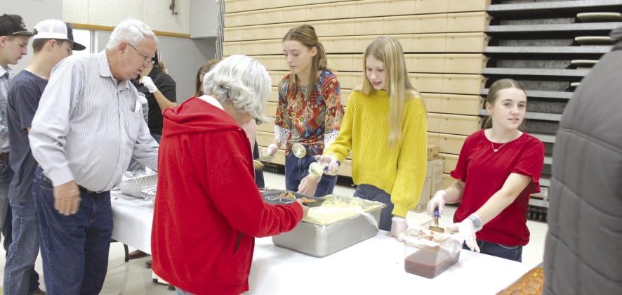 Tecumseh eighth-grade FFA members Emma Rodgers, McKenzie Benge and Madi Taron serve those attending the Tecumseh High School FFA Pig Roast on Nov. 17. Countywide &amp; Sun/Natasha Dunagan