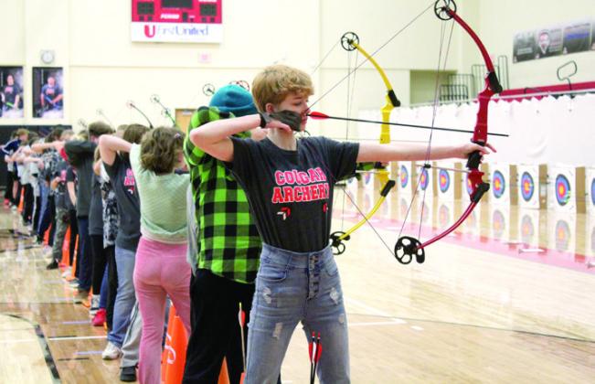 North Rock Creek student Susie Burkhead aims her compound bow during the NASP Archery Tournament held at NRC, Jan. 13-14, as up to 47 other archers do the same.