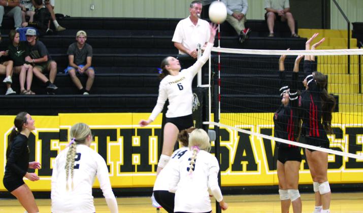 Tecumseh sophomore Kensley Whittington tips the ball over the net as two North Rock Creek players try to block in the home match on Aug. 28. Natasha Dunagan, Countywide &amp;amp; Sun