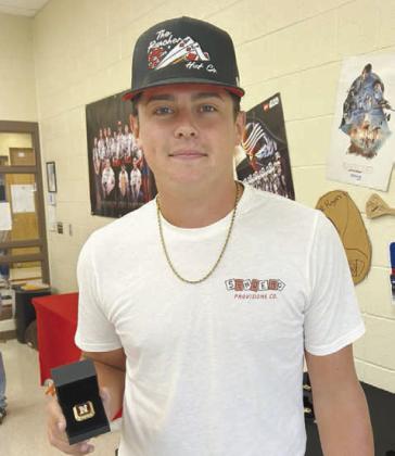 Right: Braden Ueltzen poses with his Archery State Championship ring. Ueltzen placed second in high school boys at the State Tournament but was unable to attend Nationals due to a conflict with NRC baseball state playoffs. He will be attending USAO in Chickasha this fall on a baseball scholarship. Photo Provided