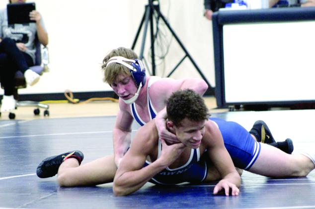 Pictured right, Shawnee’s Christien Taylor tries to flip Kade Carter.