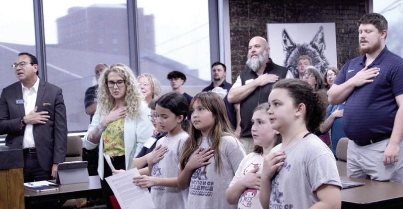 The Horace Mann Elementary Principal's Leadership Team leads the flag salute to begin the March 9 Shawnee Board of Education meeting. From left are Principal Christi Lovelady, Benjamine Willson, Lorelei Russ, Yaleni Martinez, Abigail Land and Ryleigh Bryan.
