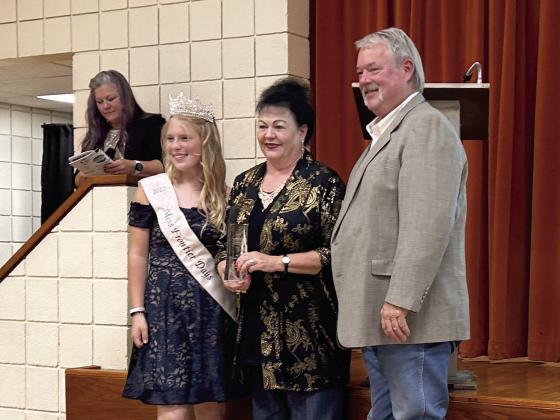 Suzanne and Randy Gilbert received the very fist Impact Award at the Tecumseh Chamber Annual Meeting and Awards Banquet held Tuesday, Nov. 14. The Gilberts are posing with 2023 Miss Frontier Days Alleigha McCullough. Countywide &amp;amp; Sun/Suzie Campbell