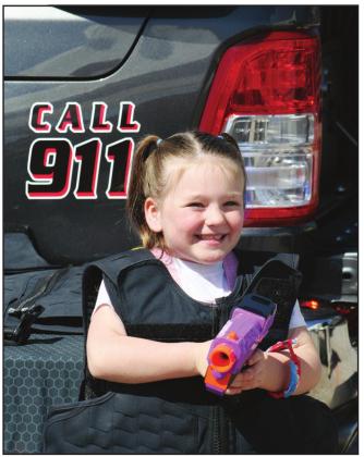 Posing with a toy gun, police vest, and an enormous smile, six-year-old Braelynn Salver attended Touch A Truch And Beyond, April 2. Countywide &amp;amp; Sun/Kendra Johnson