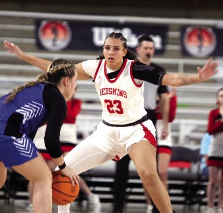 McLoud senior Taycee Lewis (#23) guards the basket during the Class 4A State Quarterfinal game against Harrah.