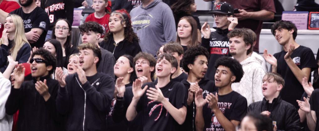 The McLoud Student Section cheer on the Lady Redskins during the Class 4A State Quarterfinal game against Harrah, at the OG&amp;E Coliseum in OKC on March 10.
